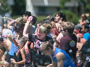Participants get soaked with water during the Spotted in Windsor Community Water Balloon Fight at Lanspeary Park, Sunday, July 26, 2015.  (DAX MELMER/The Windsor Star)