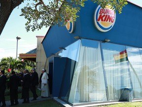 Pope Francis stands in front of a Burger King restaurant at the Christ the Redeemer square in Santa Cruz, Bolivia, Thursday, July 9, 2015. The famously unpretentious pope used the fast food joint to change into his vestments before walking to the nearby altar and celebrate Mass. (Associated Press)
