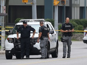 Windsor police officers investigate a suspicious package near the Windsor Regional Hospital, Ouellette Campus on Tuesday, July 7, 2015. Erie street between Goyeau and Ouellette Ave. was shut down for more than an hour as officers investigated the situation. It was determined that the package found in an alley was harmless. (DAN JANISSE/The Windsor Star)