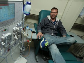 Brandon Thompson sits next to the dialysis machine his is connected to for four hours, three times a week at Hotel Dieu Hospital in Windsor on Tuesday, July 7, 2015.                        (TYLER BROWNBRIDGE/The Windsor Star)