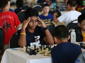 Anitej Bhaskar, from Windsor, thinks about a move during the  Canadian Youth Chess Championships hosted by The Windsor Chess Club, held at St. Clair Centre for the Arts in Windsor, Ontario on July 6, 2015. (JASON KRYK/The Windsor Star)