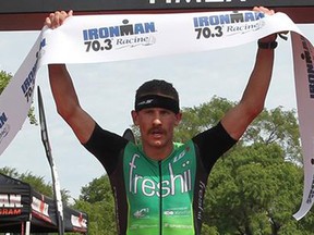 Harrow's Lionel Sanders celebrates after winning Ironman 70.3 in Racine, Wis., on Sunday, July 19, 2015.