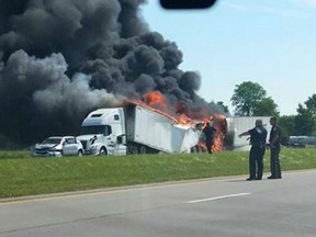 A transport truck is engulfed in flames on US-24 in Ohio on July 21, 2015. (ToledoNewsNow/Twitter)