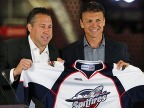 The Windsor Spitfires introduced their new head coach to the media on Friday, July 3, 2015, at the WFCU Centre in Windsor, ON. Rocky Thompson was announced as Bob Boughner's replacement. GM Warren Rychel (L) and Thompson pose with a team jersey during the event. (DAN JANISSE/The Windsor Star)