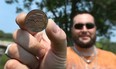 Robb Meloche shows off a Chrysler coin he found on his property near Belle River on Monday, July 6, 2015. The coins shows 1934 on one side and 1924 on the other.                        (TYLER BROWNBRIDGE/The Windsor Star)