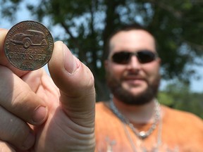 Robb Meloche shows off a Chrysler coin he found on his property near Belle River on Monday, July 6, 2015. The coins shows 1934 on one side and 1924 on the other.                        (TYLER BROWNBRIDGE/The Windsor Star)