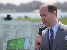 Ambassador Bridge Companies Matthew Moroun discusses his part during a news conference, Wednesday, April 29, 2015 in Detroit, in the new Riverside Park that includes swapping of land that increases the parks footprint and more than 1,000 windows that will be installed in a long-shuttered train station in Detroit. (AP Photo/Carlos Osorio)