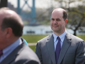 Ambassador Bridge Company's Matthew Moroun, right, looks on as Detroit Mayor Mike Duggan addresses a news conference at Riverside Park, Wednesday, April 29, 2015 in Detroit.