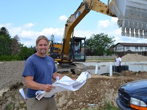Drew Coulson, general contractor and owner of Coulson Design-Build Inc., surveys building activity at the Riverfront Park Townhomes development in Amherstburg on July 2, 2015. Amherstburg is seeing a building boom with 52 new housing starts during the first six months of 2015, which translates into a 25 per cent increase over the same period last year. (JULIE KOTSIS/The Windsor Star)