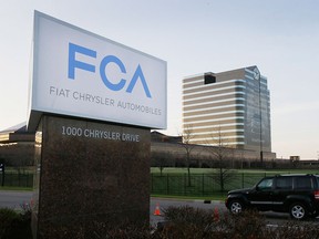 FILE - In this Tuesday, May 6, 2014, file photo, the Fiat Chrysler Automobiles sign is seen after being unveiled at Chrysler World Headquarters in Auburn Hills, Mich. The U.S. government will fine Fiat Chrysler a record $105 million for violating safety laws in a series of recalls, a person briefed on the matter says. The National Highway Traffic Safety Administration will reveal the fine on Monday, July 27, 2015, says the person who didn't want to be identified because the official announcement hasn't been made. (AP Photo/Carlos Osorio, File)