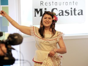 Claudia Guerrero demonstrates a folkloric El Salvadorian dance at the offices of the Downtown Windsor Business Improvement Association on July 7, 2015. (Jason Kryk / The Windsor Star)