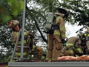 Firefighters battle a house fire on Manning Road in Tecumseh on Thursday, July 9, 2015. Firefighters quickly put the blaze out. No one was hurt in the fire.                         (TYLER BROWNBRIDGE/The Windsor Star)