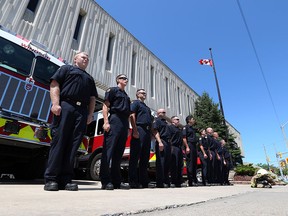 Windsor Firefighters lined up on Goyeau Avenue outside Station 1 Wednesday to pay their respects to William Tape, a former chief who served with the department for 34 years. (Jason Kryk/The Windsor Star)