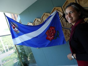 Mita Williams holds a Windsor flag at city hall in Windsor on Wednesday, July 15, 2015. Williams thinks the city needs a new flag.                         (TYLER BROWNBRIDGE/The Windsor Star)