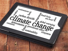 Climate change word cloud on a digital tablet against rustic barn wood. Photo by fotolia.com