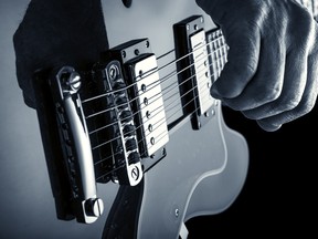 Hand of guitarist playing an electric guitar. Image by fotolia.com.
