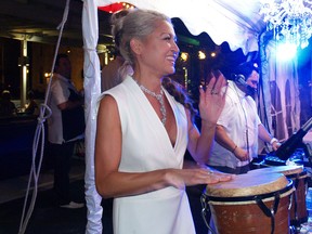 Nayeli Castellanos plays the drums at the 2015 White Party at The Willistead Restaurant on July 11, 2015. (ALEX BROCKMAN/The Windsor Star)