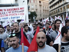 Members of the Communist-affiliated PAME labor union shout slogans during an anti-austerity rally in Athens, Wednesday, July 15, 2015. Greece has a tentative rescue deal, but relief that it is not falling out of the euro is unlikely to last long: its economy has taken a huge hit. Months of political brinkmanship, uncertainty and bank closures have hurt companies and brought everyday business to a standstill. (AP Photo/Petros Giannakouris)