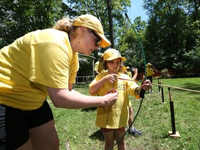 Saoirse Ross, age 6, takes part in an archery event at Camp Cedarwin in Harrow, Ontario on July 20, 2015.  Twenty-one children from Hospice who have a parent, grandparent or sibling with a diagnosis took part in the  camp day hosted by Scouts Canada.  The event featured  Canoeing,  archery, climbing, and a trip to Adventure Bay waterpark.   (JASON KRYK/The Windsor Star)