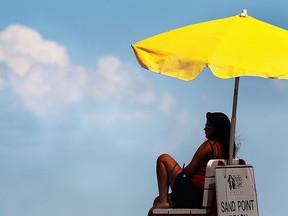 A lifeguard keeps an eye on swimmers on a hot summer day on Tuesday, July 28, 2015, at the Sandpoint Beach in Windsor, Ont. (DAN JANISSE/The Windsor Star)