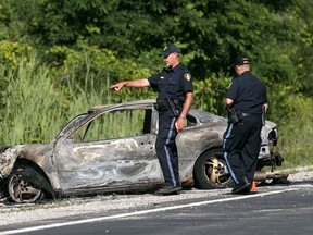 OPP officers work at the scene of a fatal two-car collision on Highway 3 between county rd. 31 and 34, Wednesday, July 15, 2015. (DAX MELMER/The Windsor Star)