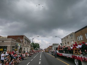 Three vintage airplanes fly over the Canada Day Parade as it makes it's way down Wyandotte St. East, Wednesday, July 1, 2015.  (DAX MELMER/The Windsor Star)