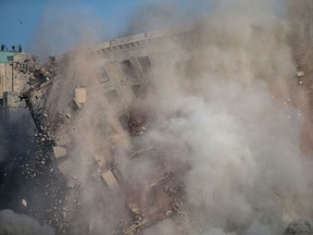 The former Park Avenue Hotel is imploded in downtown Detroit to accommodate the construction of a new sports and entertainment complex, Saturday, July 11, 2015.  200 pounds of TNT was used to bring down the 13-storey building.    (DAX MELMER/The Windsor Star)