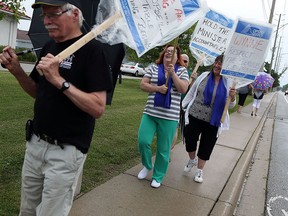 Probation officers and members of the OPSEU union hold a rally in front of their office in Windsor on Tuesday, July 7, 2015. (TYLER BROWNBRIDGE/The Windsor Star)