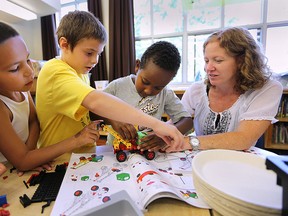 The Greater Essex County District School Board has started a summer learning program that focuses on technology and engineering. Noah Kiyoshk, 7, from left, Tristan Charette, 9, and Enoch Habtamu, 7, works with teacher Lori-Ann Murray during the program at Prince Edward School on Thursday, July 2, 2015, in Windsor, ON. (DAN JANISSE/The Windsor Star)