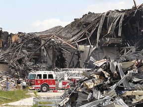 Windsor firefighters were still on scene at the Windsor Raceway on Thursday, July 2, 2015, in Windsor, ON. putting out smouldering hot spots more than 24 hours after the fire began. (DAN JANISSE/The Windsor Star)