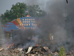 The former Windsor Raceway smoulders after an early morning fire, Wednesday, July 1, 2015. The building was in the process of being demolished. No injuries have been reported. (DAX MELMER/The Windsor Star)