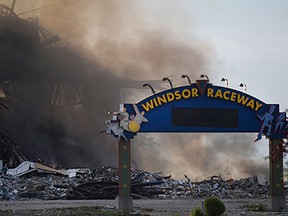 The former Windsor Raceway smoulders after an early morning fire, Wednesday, July 1, 2015.  The building was in the process of being demolished.  No injuries have been reported.  (DAX MELMER/The Windsor Star)