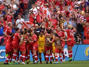 Team Canada celebrates following their 1-0 win over Switzerland following the second half of the FIFA Women's World Cup round of 16 soccer action against Switzerland in Vancouver, B.C., Sunday, June 21, 2015. THE CANADIAN PRESS/Jonathan Hayward