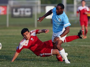 The Windsor Stars Stephen Ademolu gets tripped up by the Master's FA Farzan Mizazadeh and Deo Daniel Nash (right) at McHugh Park in Windsor on Friday, July 3, 2015.                        (TYLER BROWNBRIDGE/The Windsor Star)