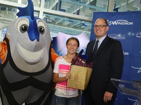 Windsor Mayor Drew Dilkens and Julianne Pella pose with Splasher, the official mascot for the FINA 2016 swimming championships, at the Windsor International Aquatic and Training Centre on Tuesday, July 14, 2015. Pella won the naming contest where hundreds of students across the city submitted name ideas for the mascot. (DYLAN KRISTY/The Windsor Star)