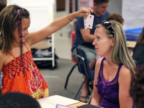 The Windsor-Essex Catholic District School Board is offering summer school programs to help students keep their math skills sharp. Parents were invited to participate with their children on Wednesday, July 22, 2015, at the HJ Lassaline School in Windsor, ON. Irene White and her daughter Addyson, 7, play a math game during the event. (DAN JANISSE/The Windsor Star)
