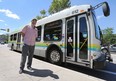 Kieran McKenzie is shown next to a Transit Windsor bus on Tuesday, July 21, 2015, on Ouellette Ave. in Windsor, ON. He is part of a group that is challenging local citizens and politicians to take the public transit challenge. (DAN JANISSE/The Windsor Star)