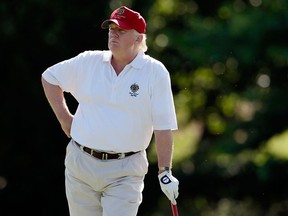 Donald Trump stands on the 14th fairway during a pro-am round of the AT&T National golf tournament at Congressional Country Club in Bethesda, Md., on June 27, 2012. (Associated Press files)