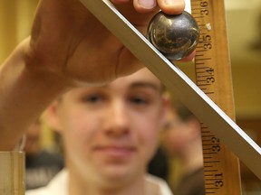 Essex High School student, Mark Armstrong, 17, conducts a physics experiment during the University of Windsor faculty of science,  Science Academy Program on July 9, 2015.   Top secondary school science students were invited to the University of Windsor to get a feel for the science program. (JASON KRYK/The Windsor Star)