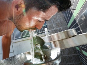 Carlos Spiel takes a refreshing drink of water at a water fountain located at the Festival Plaza in downtown Windsor, Ontario on July 28, 2015.   (JASON KRYK/The Windsor Star)
