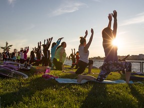 People practice yoga at Karma Yoga by the Water on Windsor's riverfront east of the Caron Ave. Pumping Station, Wednesday, July 15, 2015. (DAX MELMER/The Windsor Star)