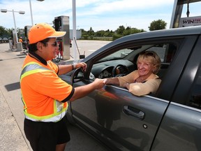 Motorist Linda Iler, from Windsor thanks Dave's Big Chief gas station attendant Nadal Eljayeh for his service at the Big Chief gas station on Tecumseh Road East in Tecumseh, Ontario on August 6, 2015. (JASON KRYK/The Windsor Star)