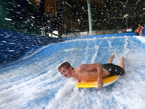 Daulton Smith, 14, of Cottam rides the flowrider at the  Adventure Bay Family Water Park in Windsor, Ont., on Wednesday, August 12, 2015. The budget to run the facility has been significantly higher than originally anticipated. (DAN JANISSE/The Windsor Star)