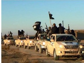 FILE - This file image posted on a militant website on Tuesday, Jan. 7, 2014, which is consistent with AP reporting, shows a convoy of vehicles and fighters from the al-Qaida linked Islamic State of Iraq and the Levant (ISIL) fighters in Iraq's Anbar Province. The Islamic State group holds roughly a third of Iraq and Syria, including several strategically important cities like Fallujah and Mosul in Iraq and Raqqa in Syria. It rules over a population of several million people with its strict interpretation of Islamic law.