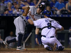 Ian Kinsler #3 of the Detroit Tigers slides past Drew Butera #9 of the Kansas City Royals to score on a fielder's choice in the eighth inning at Kauffman Stadium on August 12, 2015 in Kansas City, Missouri. (Photo by Ed Zurga/Getty Images)