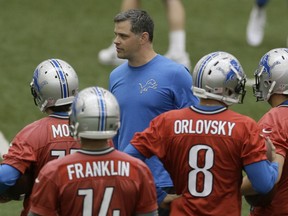 Detroit Lions offensive coordinator Joe Lombardi talks to the quarterbacks during an NFL football organized team activity in Allen Park, Mich., Wednesday, May 28, 2014. (AP Photo/Carlos Osorio)