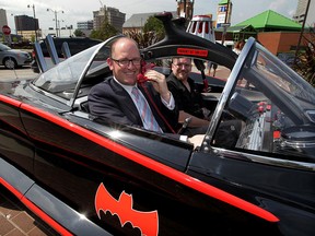 Another day at the office for Mayor Drew Dilkens as he accepts a ride in the Batmobile during a kickoff of Windsor ComiCon Friday August 14, 2015. Crowds approaching 5,000 are expected as a variety of stars and personalities make the rounds over the weekend at Caesars Windsor. (NICK BRANCACCIO/The Windsor Star)