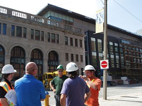 Nearing completion, supervisors have a discussion outside University of Windsor's new School of Social Work and Centre for Executive and Professional Education at Pitt and Ferry Streets August 19, 2015.  Some university employees were moving into the facility Wednesday. (NICK BRANCACCIO/The Windsor Star)