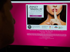 A man looks at the Ashley Madison website in this photo illustration in Toronto on Thursday, August 20, 2015. THE CANADIAN PRESS/Graeme Roy