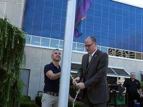 David Lenz and Mayor Drew Dilkens raise the pride flag over city hall in Windsor on Wednesday, August 5, 2015. (TYLER BROWNBRIDGE/The Windsor Star)